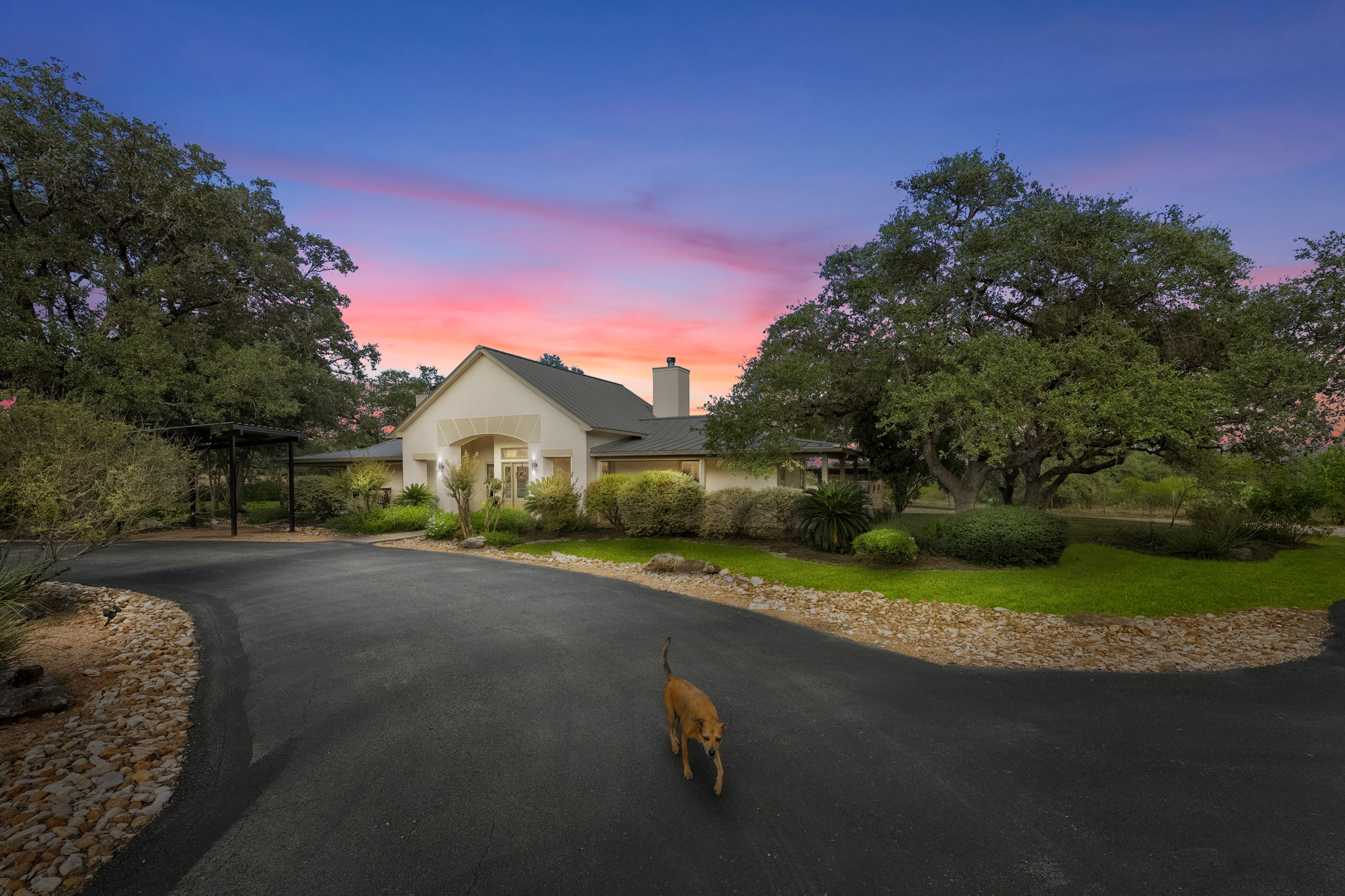 Gated approach to 22050 Hanging Oak at dusk
